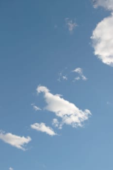 white puffy clouds in a blue sky