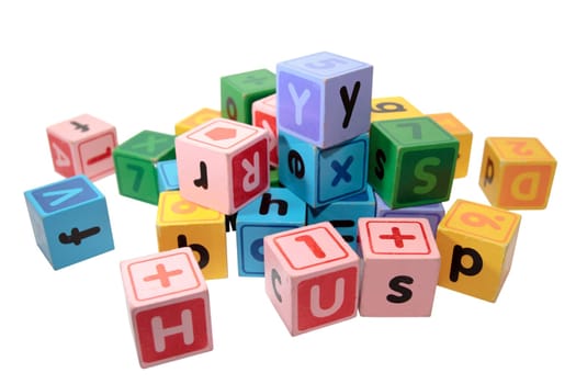 assorted childrens toy letter building blocks against a white background