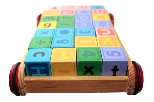 childrens toy letter building blocks all together in a toy cart isolated on white background