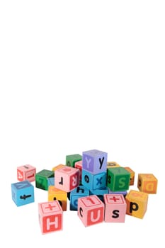 assorted childrens toy letter building blocks against a white background with copy space