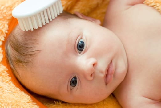 Mummy brushing her son with comb