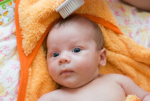 mother brushing her son with comb