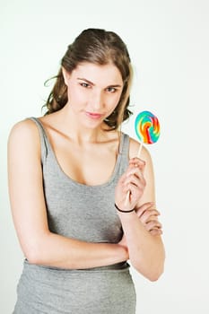 Portrait of smiling teenager girl holding colorful lollipop