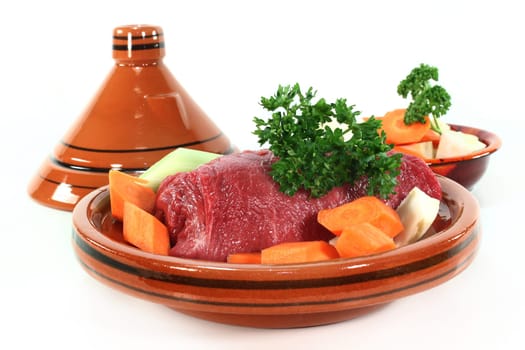 raw roast beef with vegetables in a tagine