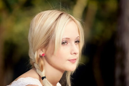 Outdoor portrait of a beautiful young woman in the park