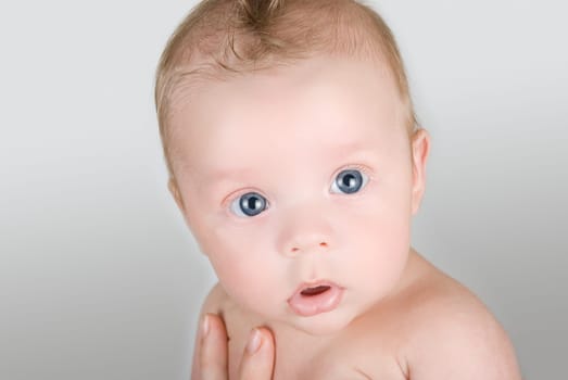 Beauty baby boy at mother hand isolated on a white background