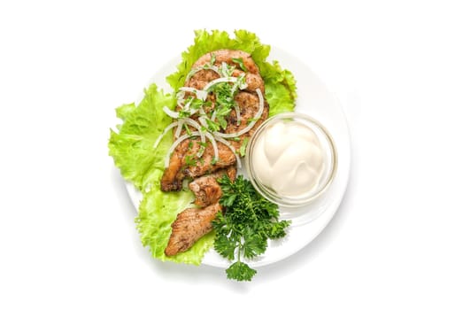 Roast meat with sauce and vegetables isolated on white background