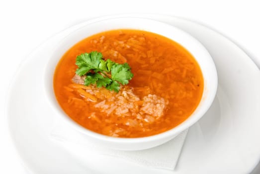 Bowl of vegetable borscht soup isolated on white