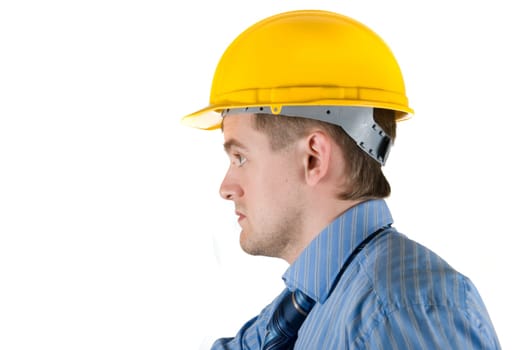 Young business man at yellow helmet isolated on white