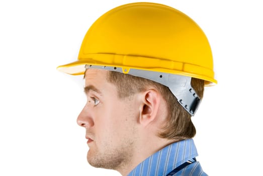 Young business man at yellow helmet isolated on white