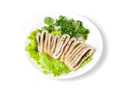 sliced squid and green vegetables dish isolated on white