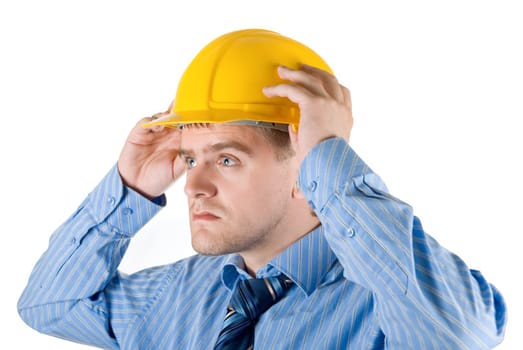 Young business man at yellow helmet isolated on white