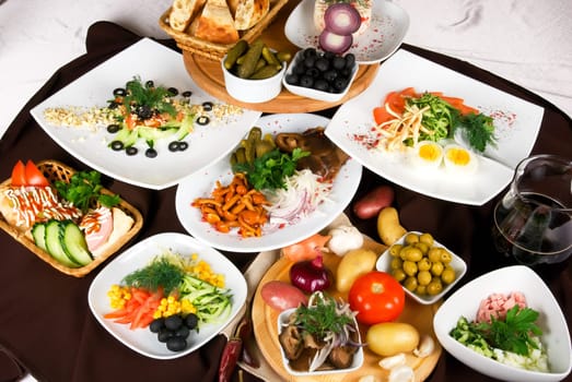 Many food dishes on the restaurant table.