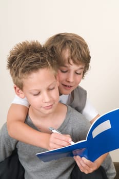 Two friends doing their homework in the livingroom