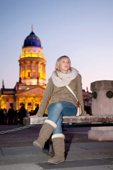 Young woman in the city in the evening