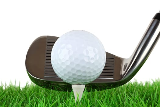 Golf club with ball on tee on meadow
