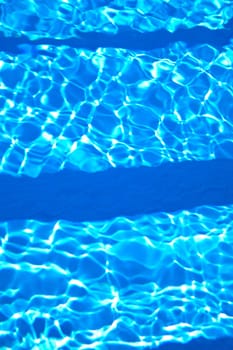 Close-up of beautiful blue water ripples in a swimming pool