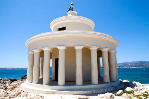 Lighthouse with blue sea in the background in Argostoli, Kefalonia, Greece