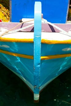 Detail of an old turquoise fishing boat in Greece