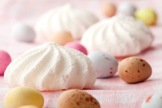 Close-up of pastel colored chocolate Easter egg candy with white meringue