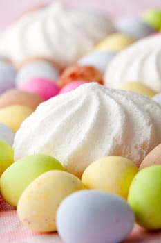 Close-up of pastel colored chocolate Easter egg candy with white meringue