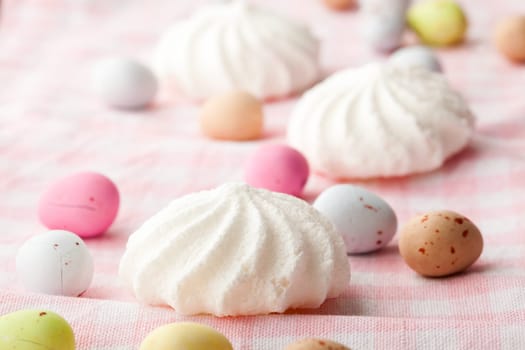 Close-up of pastel colored chocolate Easter egg candy with white meringue