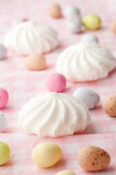 Close-up of pastel colored chocolate Easter egg candy with white meringue