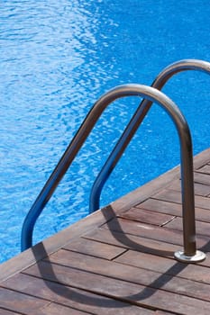 Ladder and handrail on the banks of a swimming pool