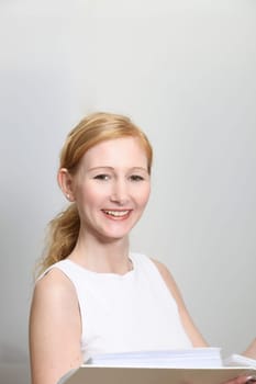 Pretty woman in office with documents in hand - portrait
