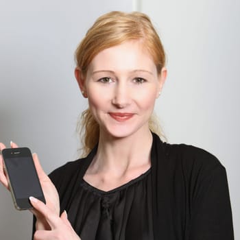 Young smiling woman presenting her smartphone - square