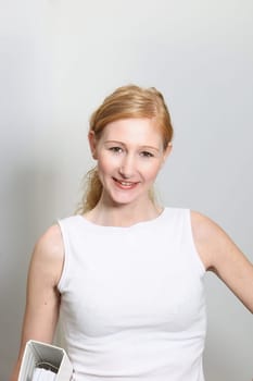 Young,pretty woman with file folder in office - portrait format