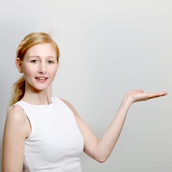 Young Pretty Woman Smiling And Presenting Something - Square