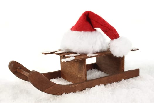 a sleigh with a Santa hat in the snow