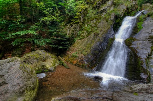 Shot of the fall of water. Stream Huntava - natural area - nature preserve. Resov, Czech republic, Europe.