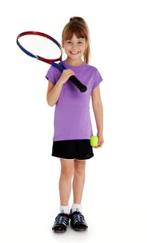 Full length studio photo of seven year old girl holding tennis racket and tennis ball isolated on white.