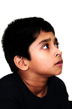 An handsome Indian kid awestruck watching television