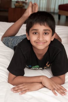 A handsome indian kid smiling for you