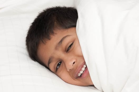 A handsome indian kid smiling for you