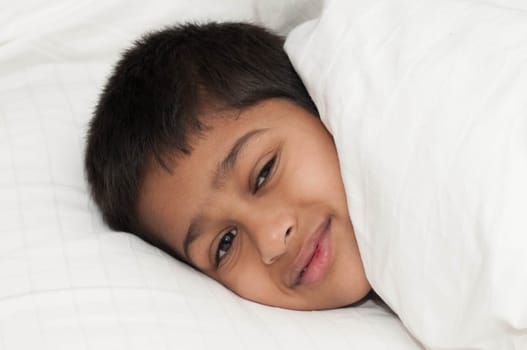A handsome indian kid smiling for you