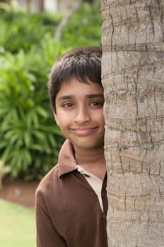 An handsome Indian kid peeping thru the trunk