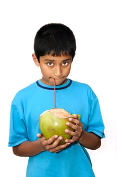 An handsome Indian kid drinking coconut water to cool off