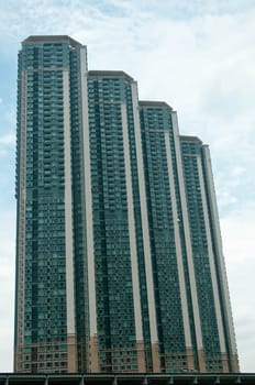 Tall residential apartments touching the blue  sky