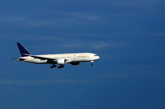 An aeroplane with landing gears switched on and ready to land
