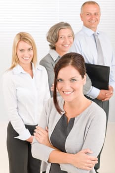 Business team attractive young businesswoman with happy mature colleagues