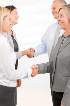 Business partners close successful deal happy people shaking hands agreement