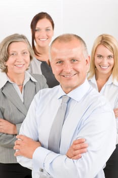 Business team senior businessman with attractive happy colleagues in office