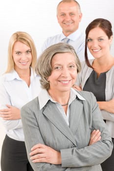 Business team senior businesswoman with attractive happy colleagues in office