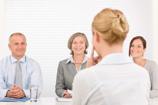 Business interview young woman being examined by professional manager team