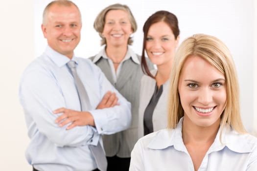 Business team attractive young businesswoman with happy mature colleagues