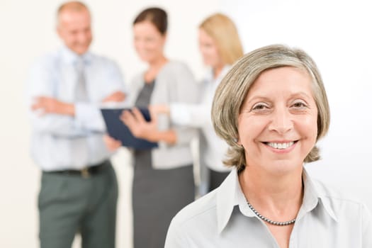 Business team close-up of senior businesswoman with attractive happy colleagues